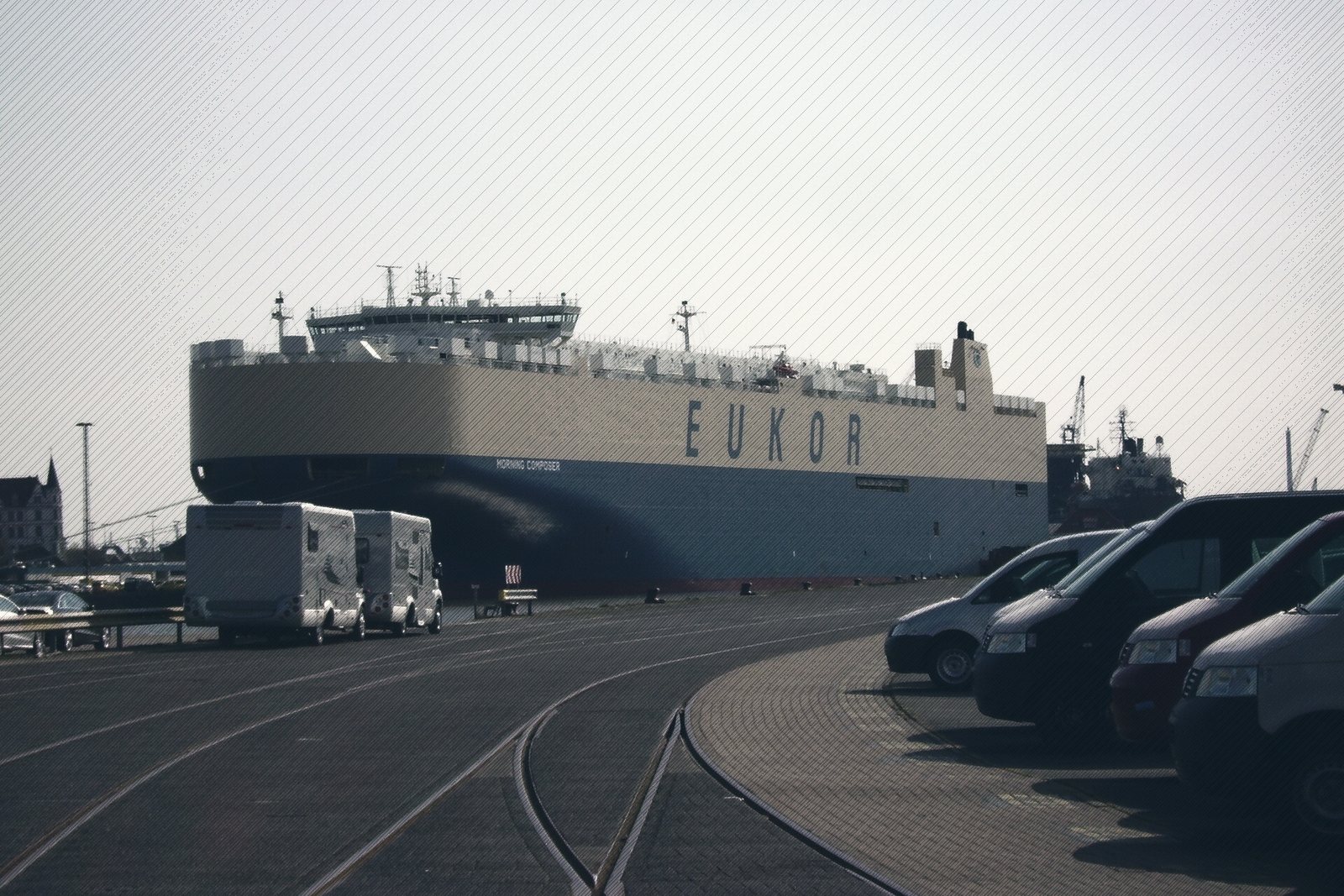 A large car-carrier ship moored at a port vehicle terminal
