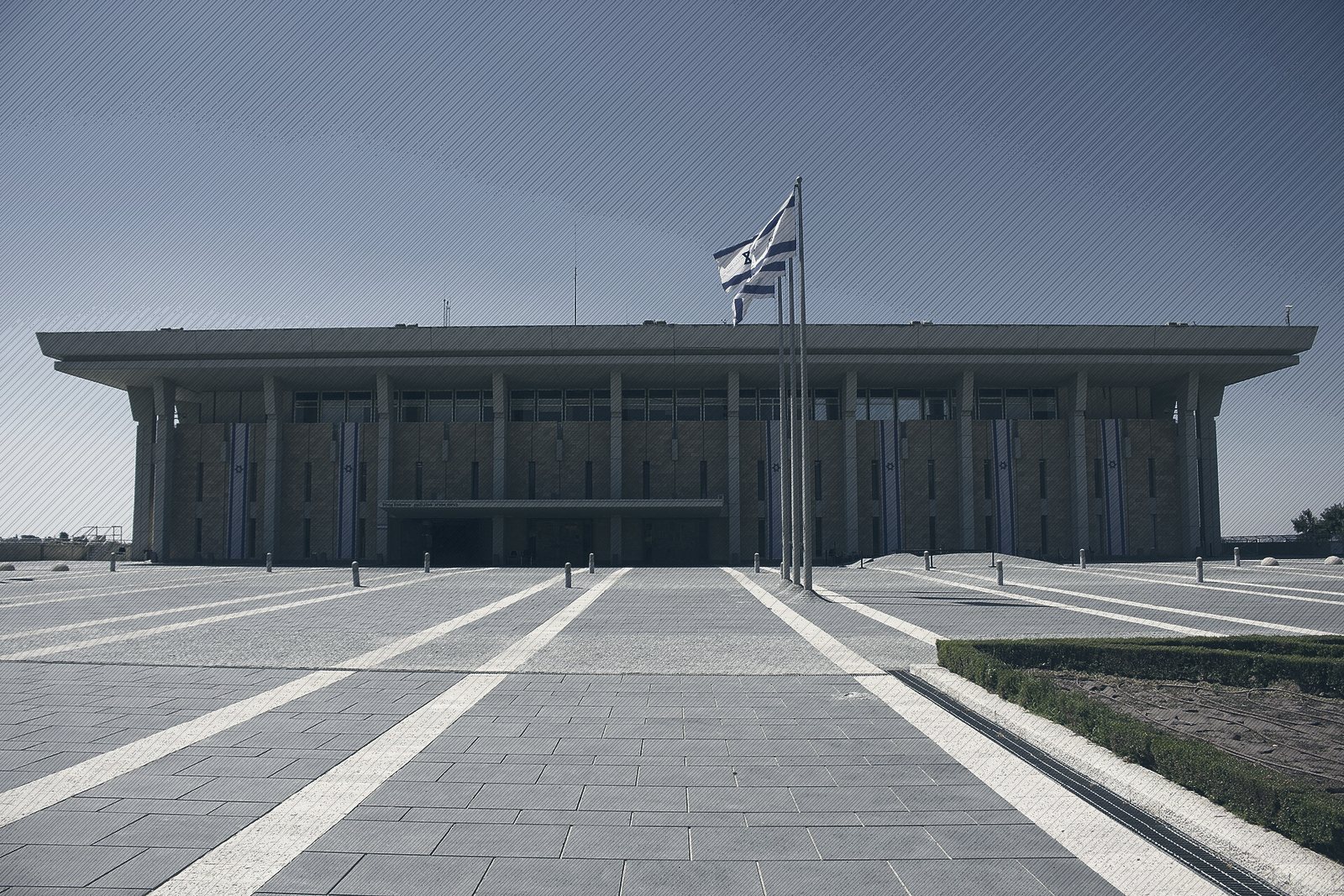 The Knesset building in Jerusalem with the Israeli flag flying in front