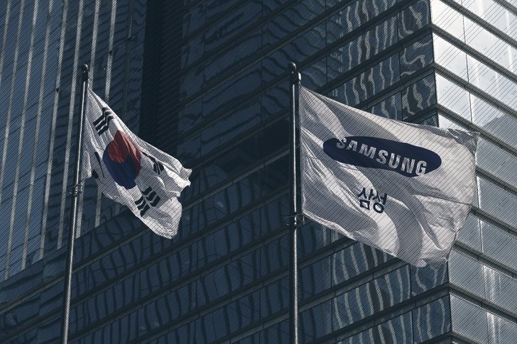 The South Korean and Samsung flags fly outside the company's glass headquarters in Seoul